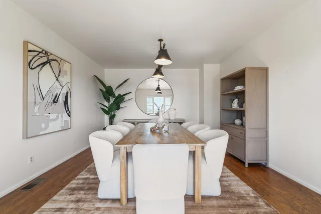 a living room with table and chairs