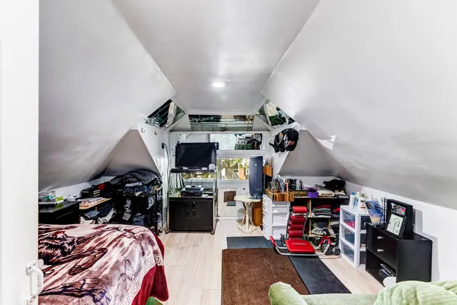 a kitchen with lots of clutter and stainless steel appliances