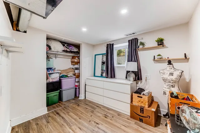 a room with window and dresser