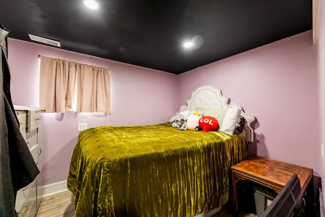 a bedroom with a bed and a dresser