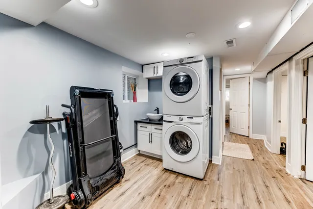 a view of a storage and utility room with washer and dryer