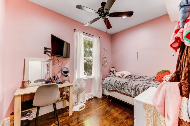 a bedroom with a bed window and a flat screen tv
