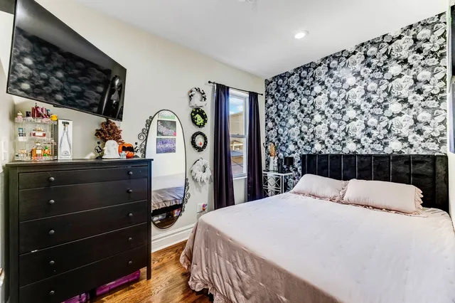 a bedroom with a bed and a dresser