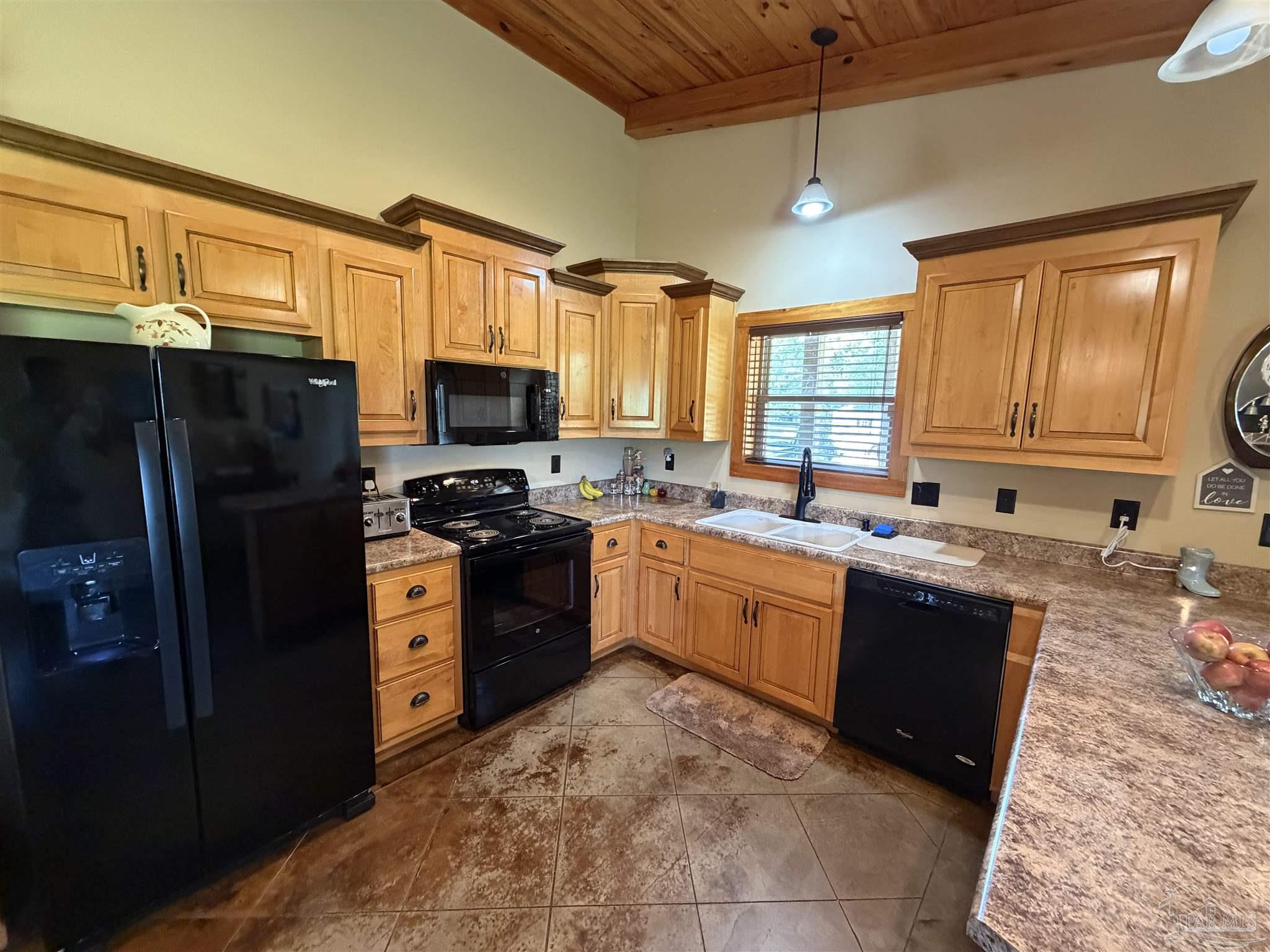 145 Tower Road Uriah, AL 36480 - Photo 5 of 72 a large kitchen with granite countertop a stove refrigerator and microwave