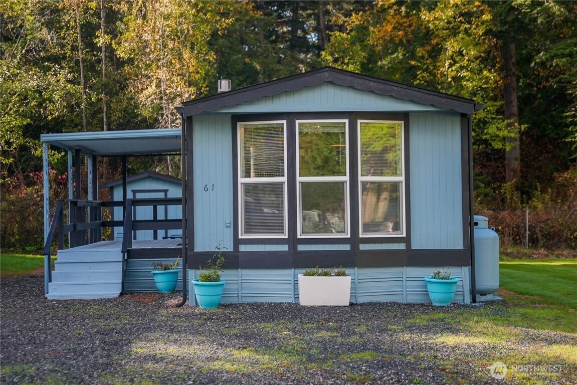 4672 Birch Bay Lynden Road, Unit 61 Birch Bay, WA 98230 - Photo 1 of 11 a front view of a house with a yard