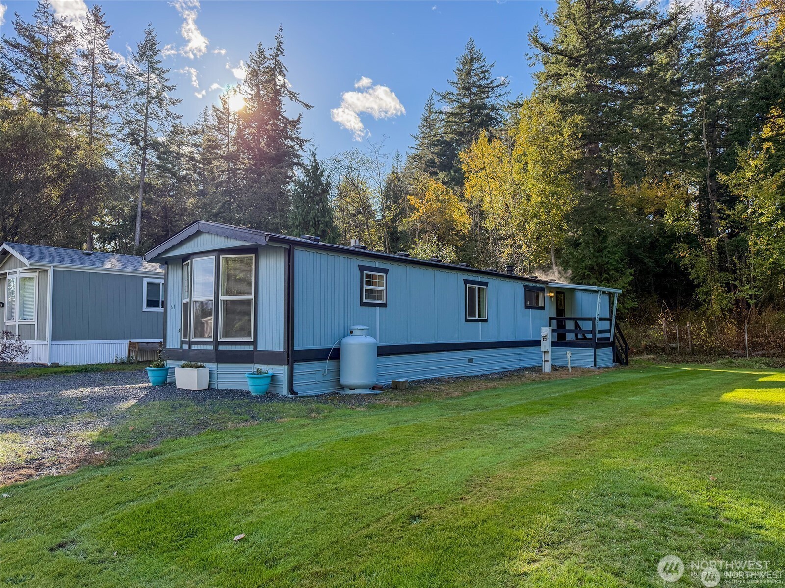 4672 Birch Bay Lynden Road, Unit 61 Birch Bay, WA 98230 - Photo 10 of 11 a house view with a sitting space and garden