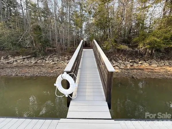 a view of a wooden deck with a lake view