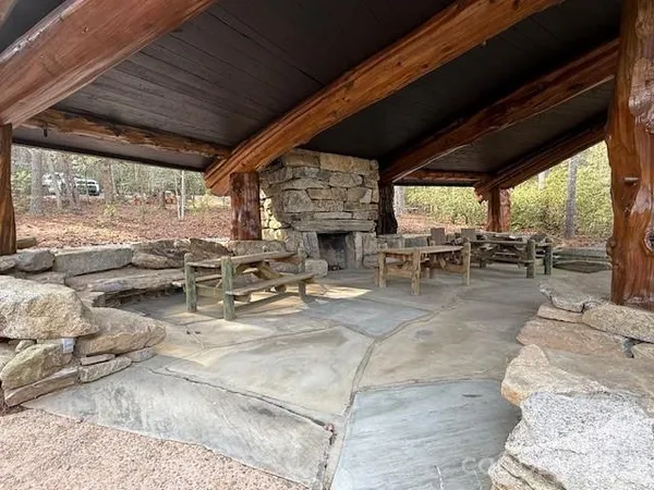 a view of a patio with table and chairs next to a yard