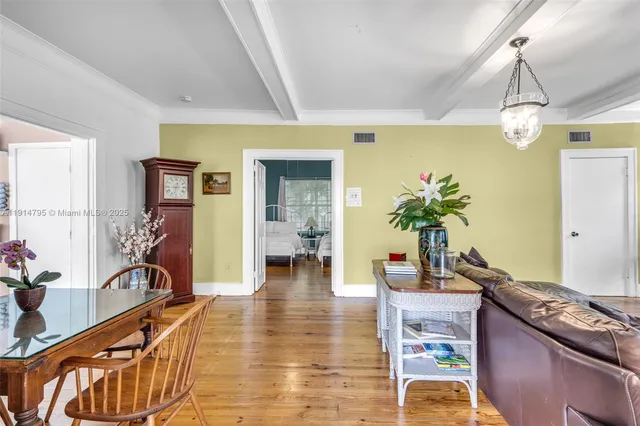 a living room with furniture a chandelier and a flat screen tv