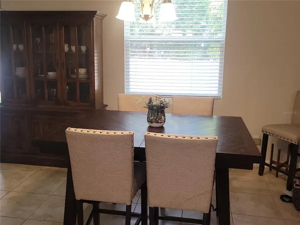 a dining room with furniture and window