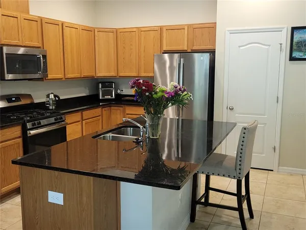 a kitchen with a refrigerator and a stove