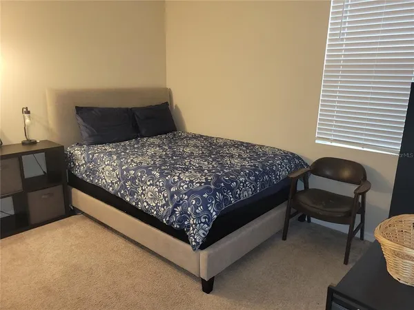 a bedroom with bed and a closet