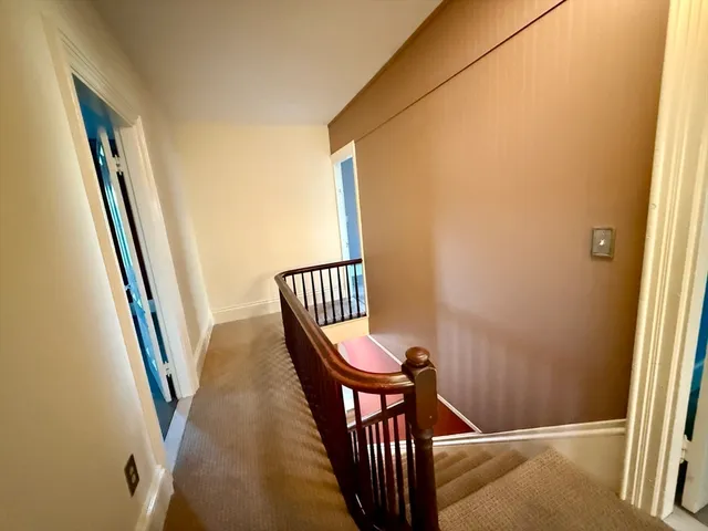 a view of a hallway with staircase