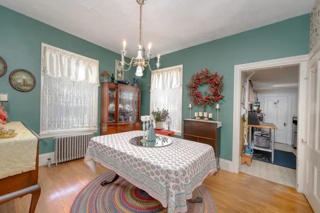 a dining room with furniture a chandelier and window