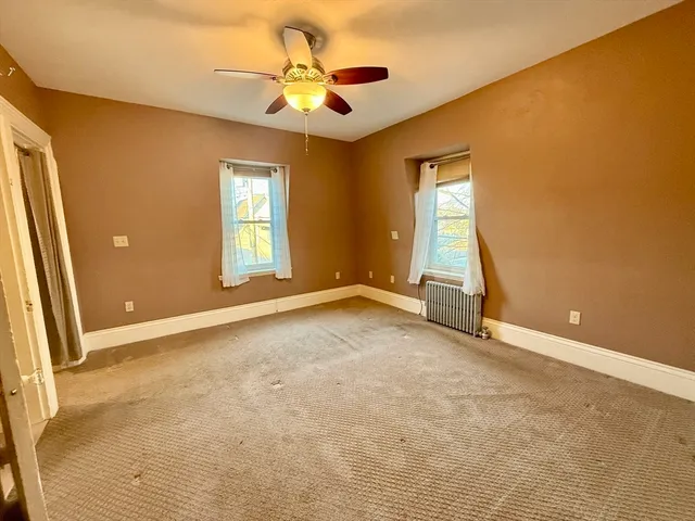 an empty room with a empty space and windows