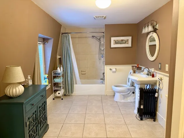 a bathroom with a sink a toilet and a mirror