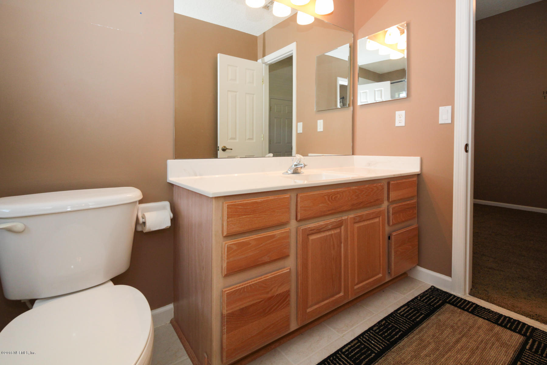1868 South Landguard Road St. Augustine, FL 32092 - Photo 54 of 65 a bathroom with a toilet sink and mirror