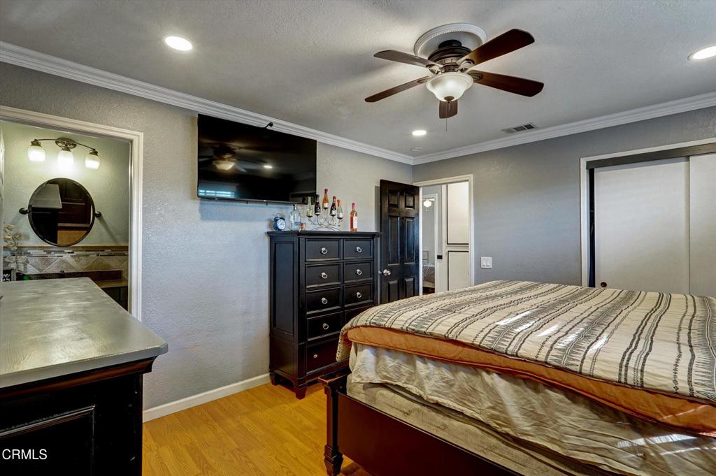 1960 Peoria Place Oxnard, CA 93033 - Photo 20 of 36 a bedroom with a bed and a flat screen tv