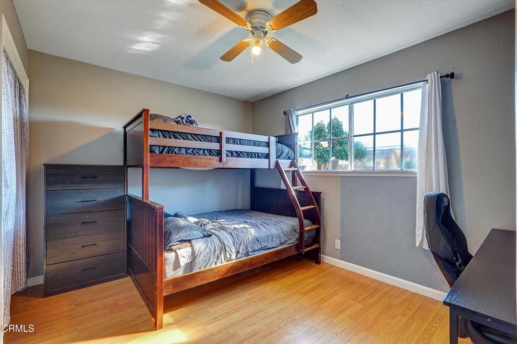 1960 Peoria Place Oxnard, CA 93033 - Photo 22 of 36 a bedroom with a bed and a chandelier