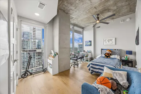 a bedroom with furniture and a large window