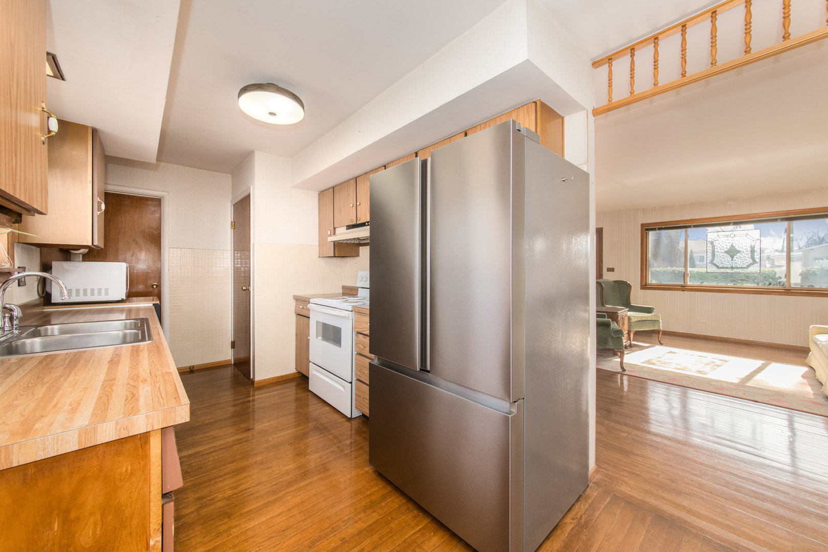 170 Westmere Road Des Plaines, IL 60016 - Photo 5 of 21 a kitchen with a refrigerator sink and wooden floor
