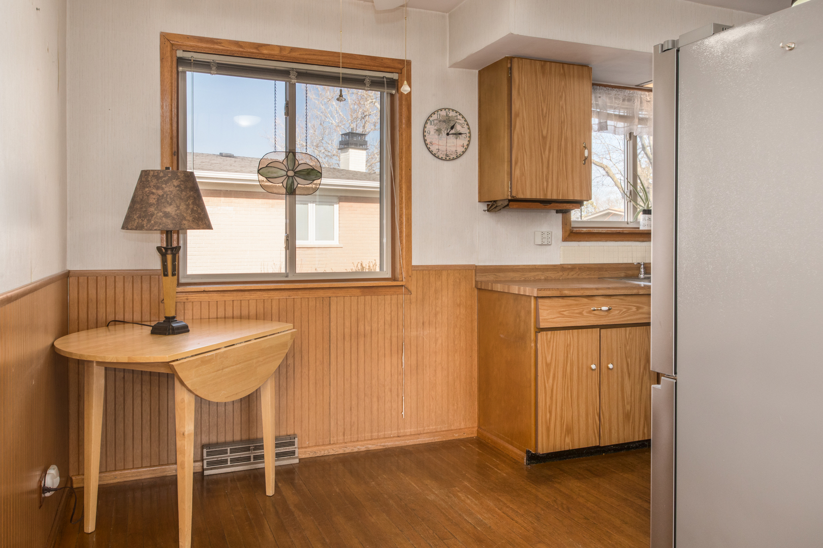 170 Westmere Road Des Plaines, IL 60016 - Photo 8 of 21 a view of a kitchen area with furniture wooden floor and window