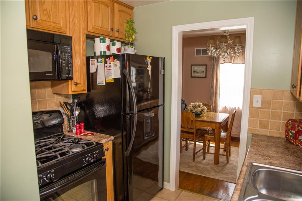 1648 Elderslee Road Pittsburgh, PA 15227 - Photo 14 of 25 Gas Stove, Microwave, and Refrigerator