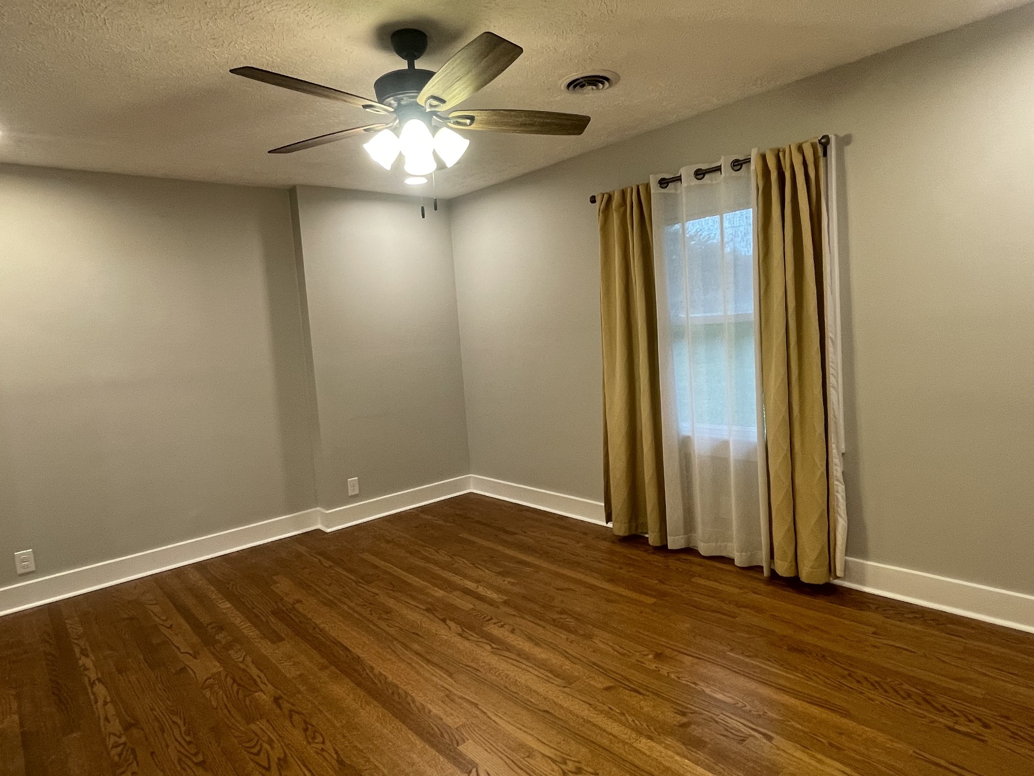 4467 Highway 431 Springfield, TN 37172 - Photo 31 of 47 an empty room with wooden floor fan and windows