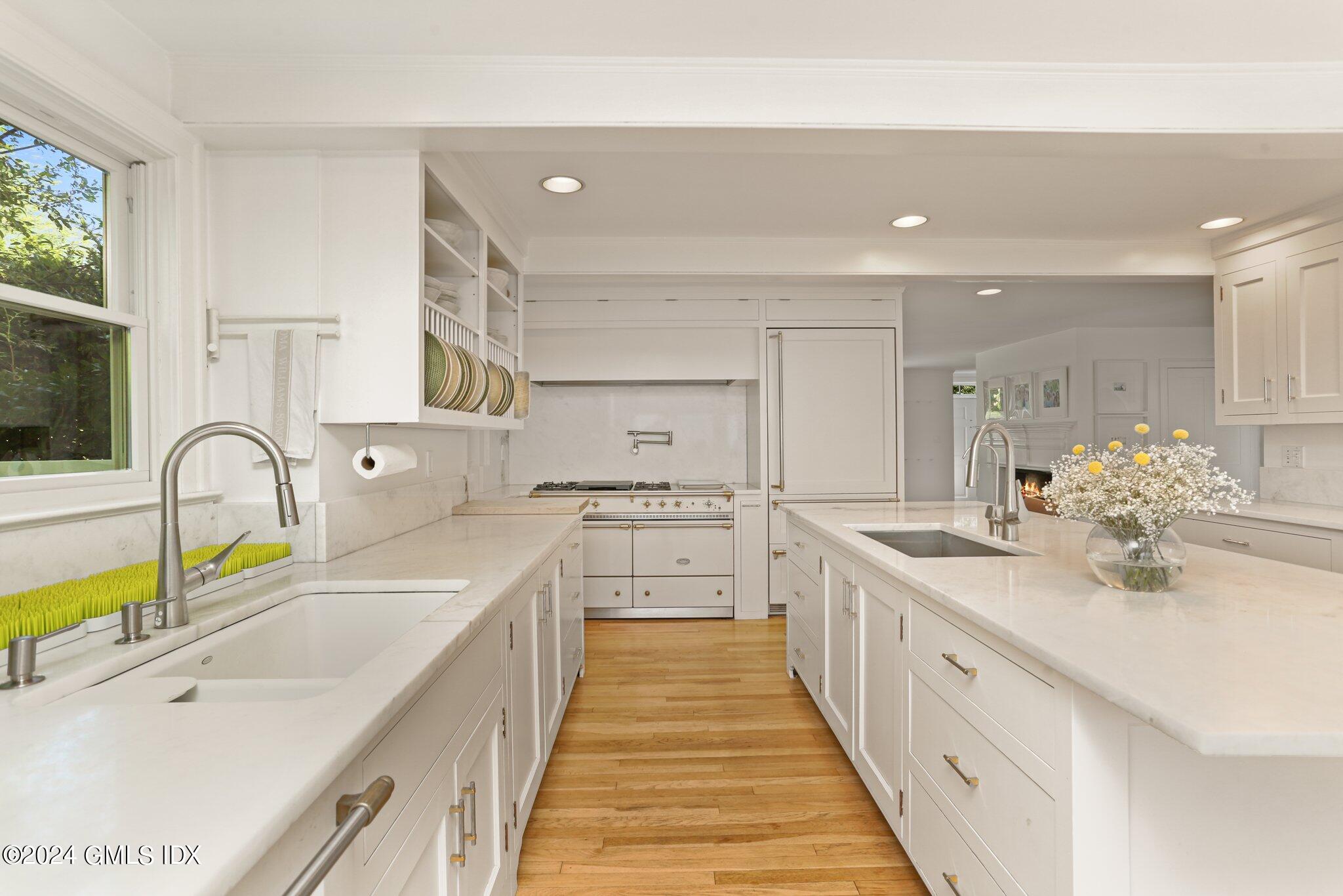 127 Dingletown Road Greenwich, CT 06830 - Photo 15 of 54 a large white kitchen with kitchen island a sink stainless steel appliances and cabinets