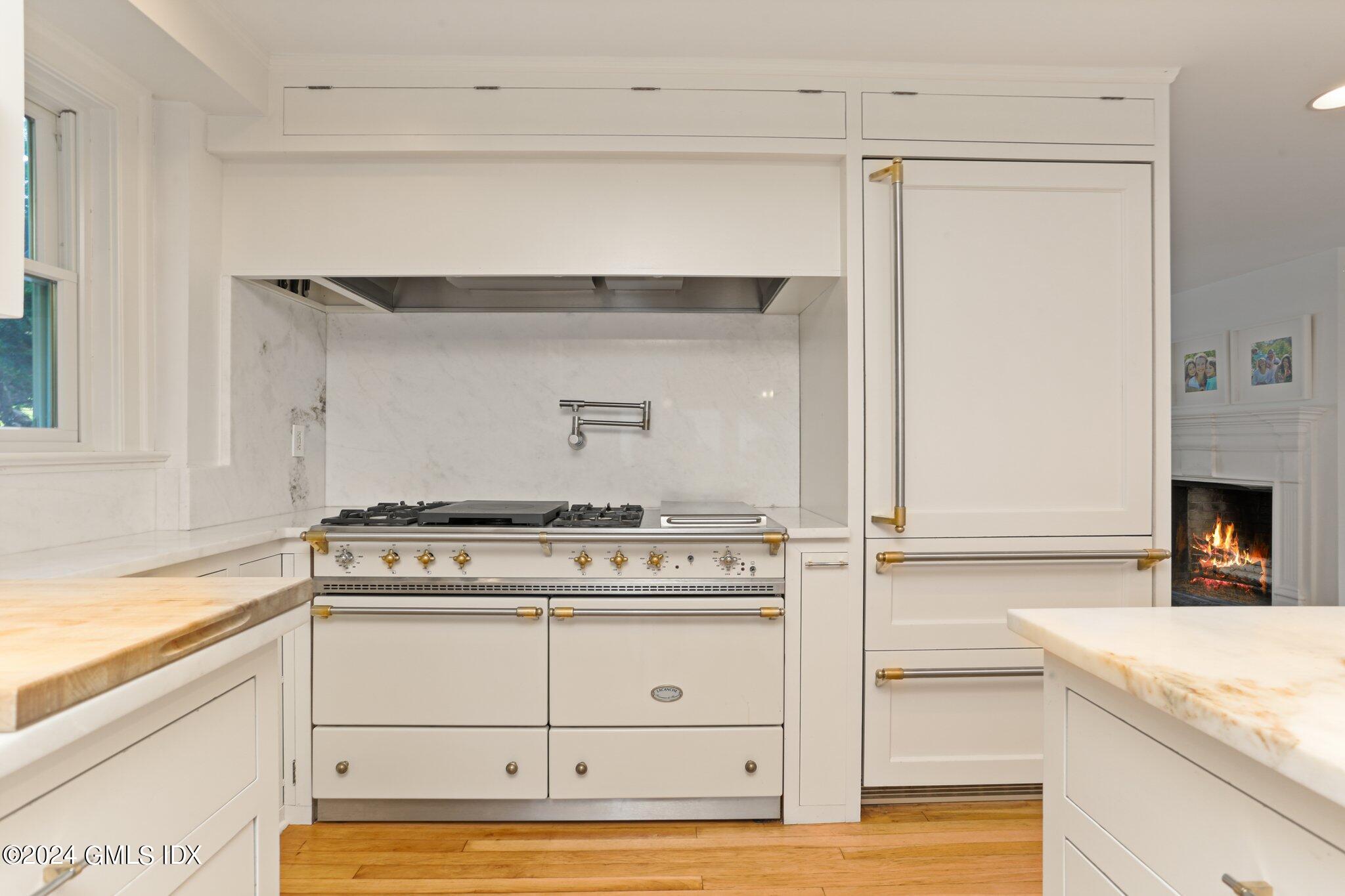 127 Dingletown Road Greenwich, CT 06830 - Photo 16 of 54 a stove top oven sitting inside of a kitchen