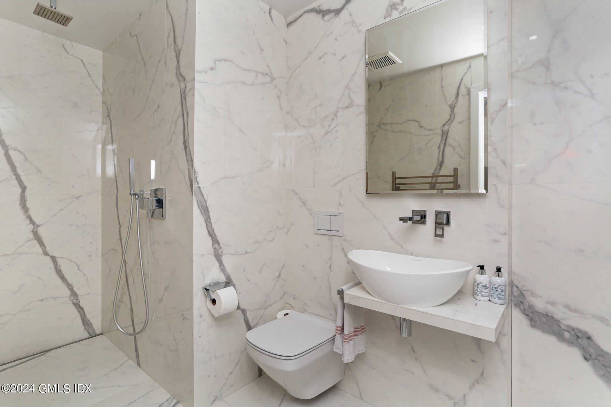 127 Dingletown Road Greenwich, CT 06830 - Photo 30 of 54 a bathroom with a toilet sink and a mirror