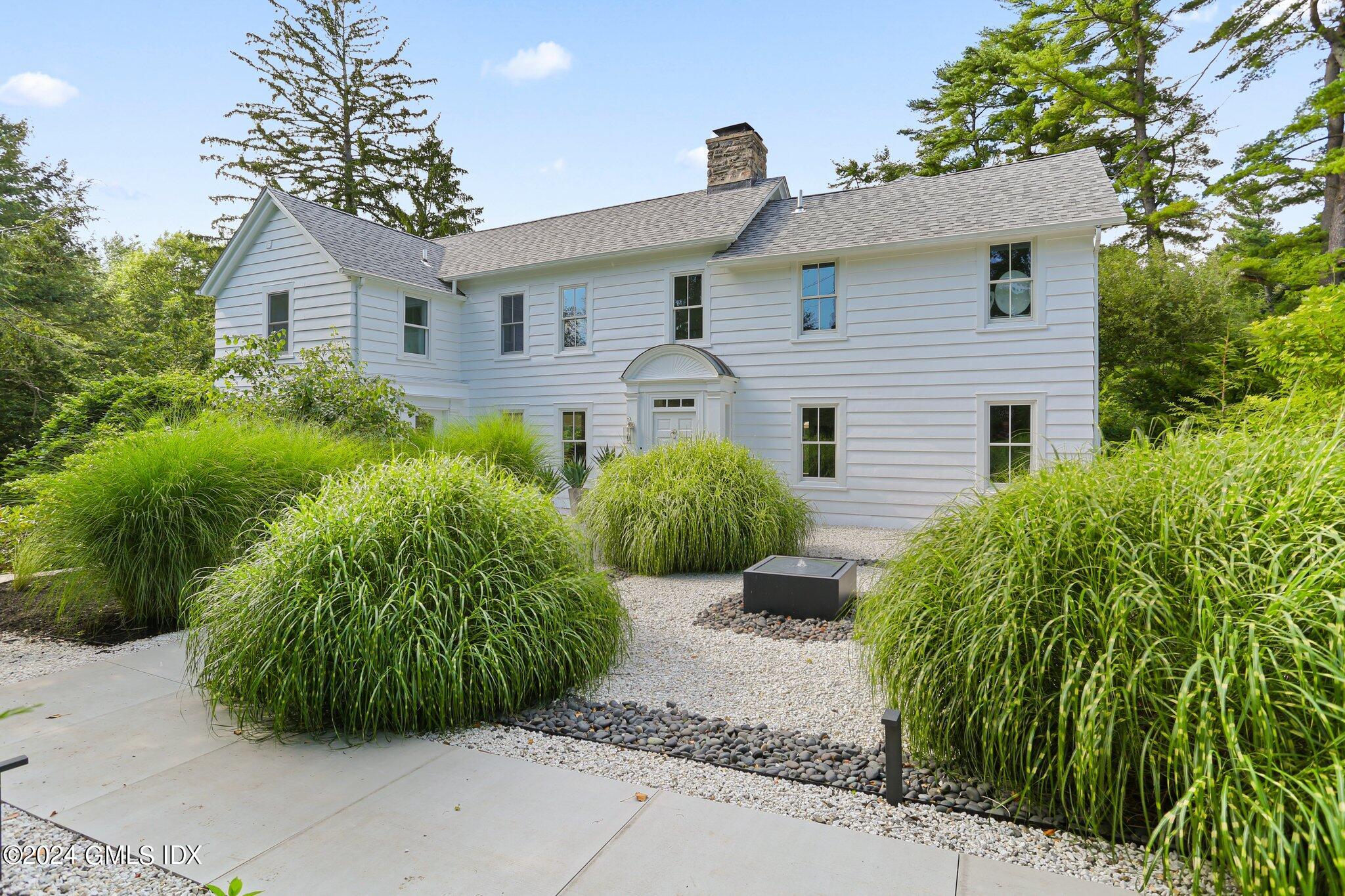 127 Dingletown Road Greenwich, CT 06830 - Photo 3 of 54 a front view of a house with garden
