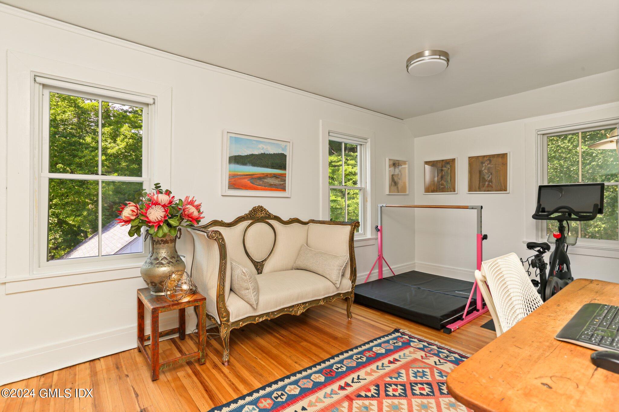 127 Dingletown Road Greenwich, CT 06830 - Photo 31 of 54 a living room with furniture a flat screen tv and a floor to ceiling window