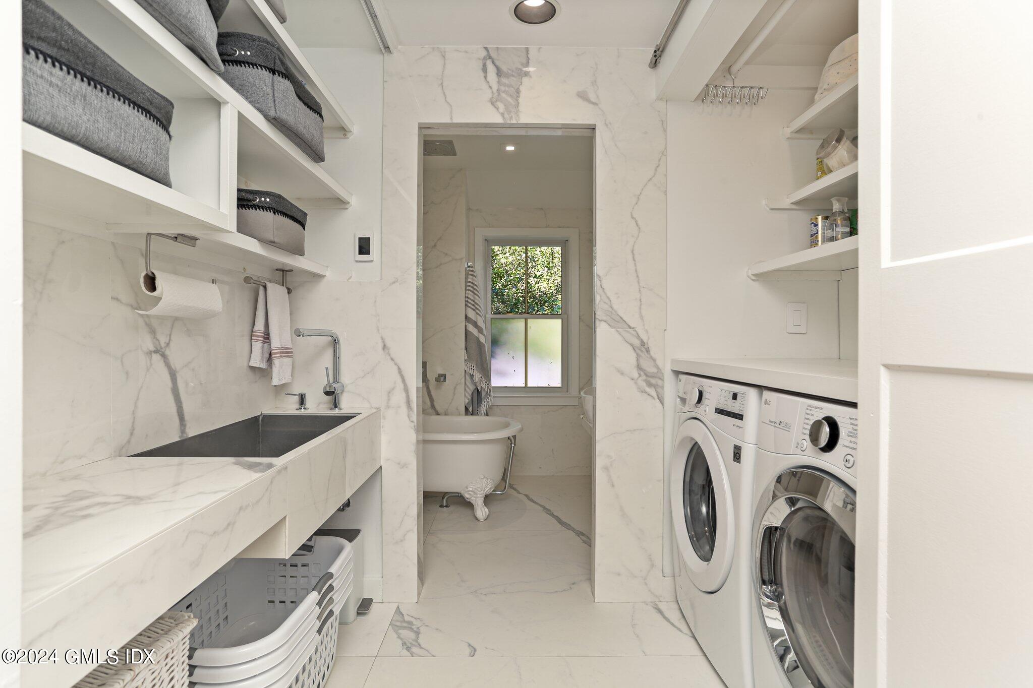 127 Dingletown Road Greenwich, CT 06830 - Photo 33 of 54 a bathroom with a sink a washer and dryer