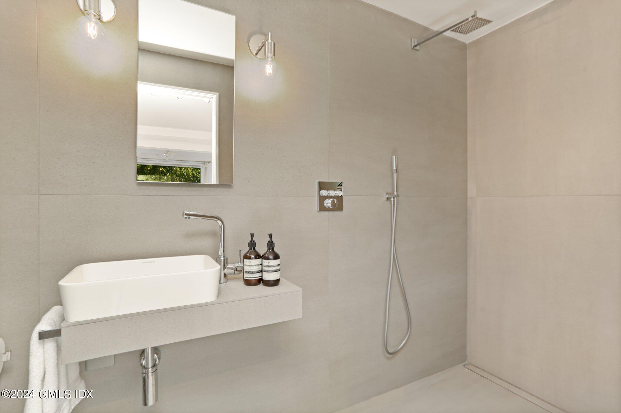 127 Dingletown Road Greenwich, CT 06830 - Photo 36 of 54 a bathroom with a sink a toilet and mirror