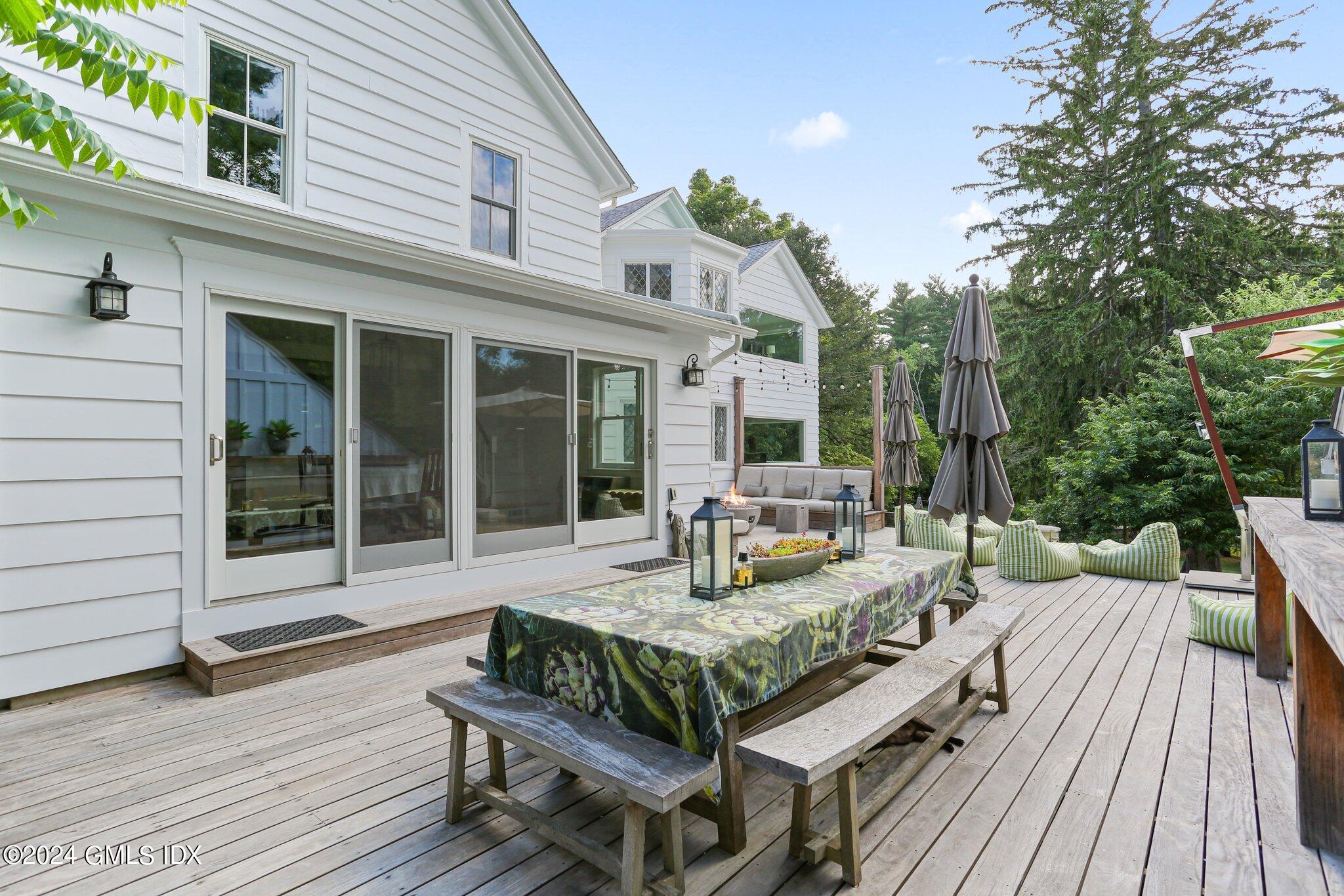 127 Dingletown Road Greenwich, CT 06830 - Photo 38 of 54 a view of house with deck outdoor seating and wooden floor