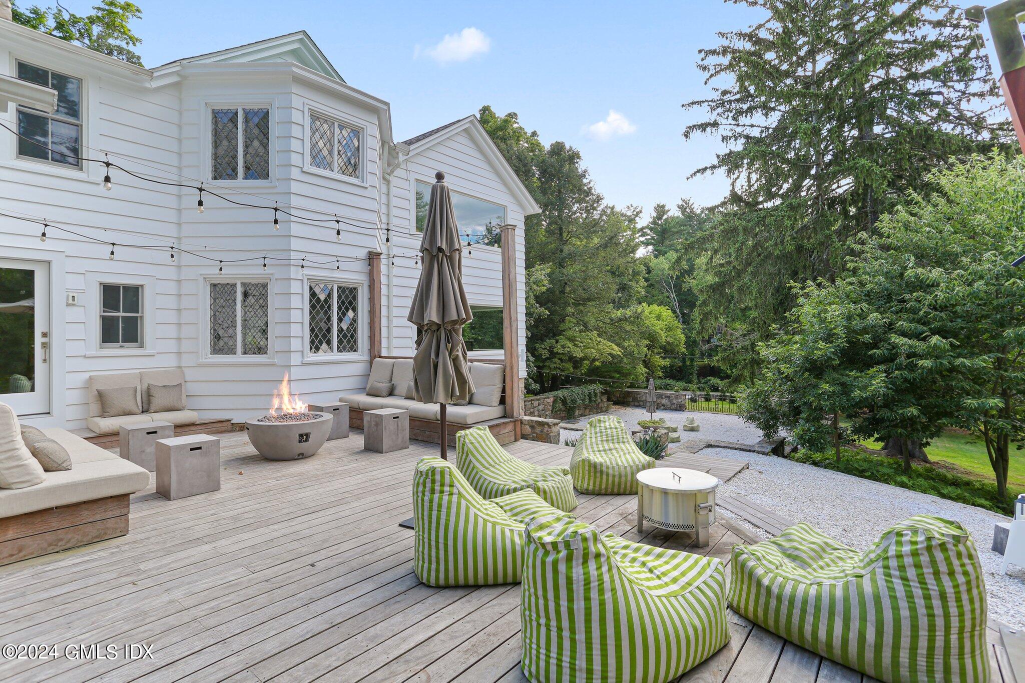 127 Dingletown Road Greenwich, CT 06830 - Photo 39 of 54 a view of a deck with couches table and chairs and potted plants