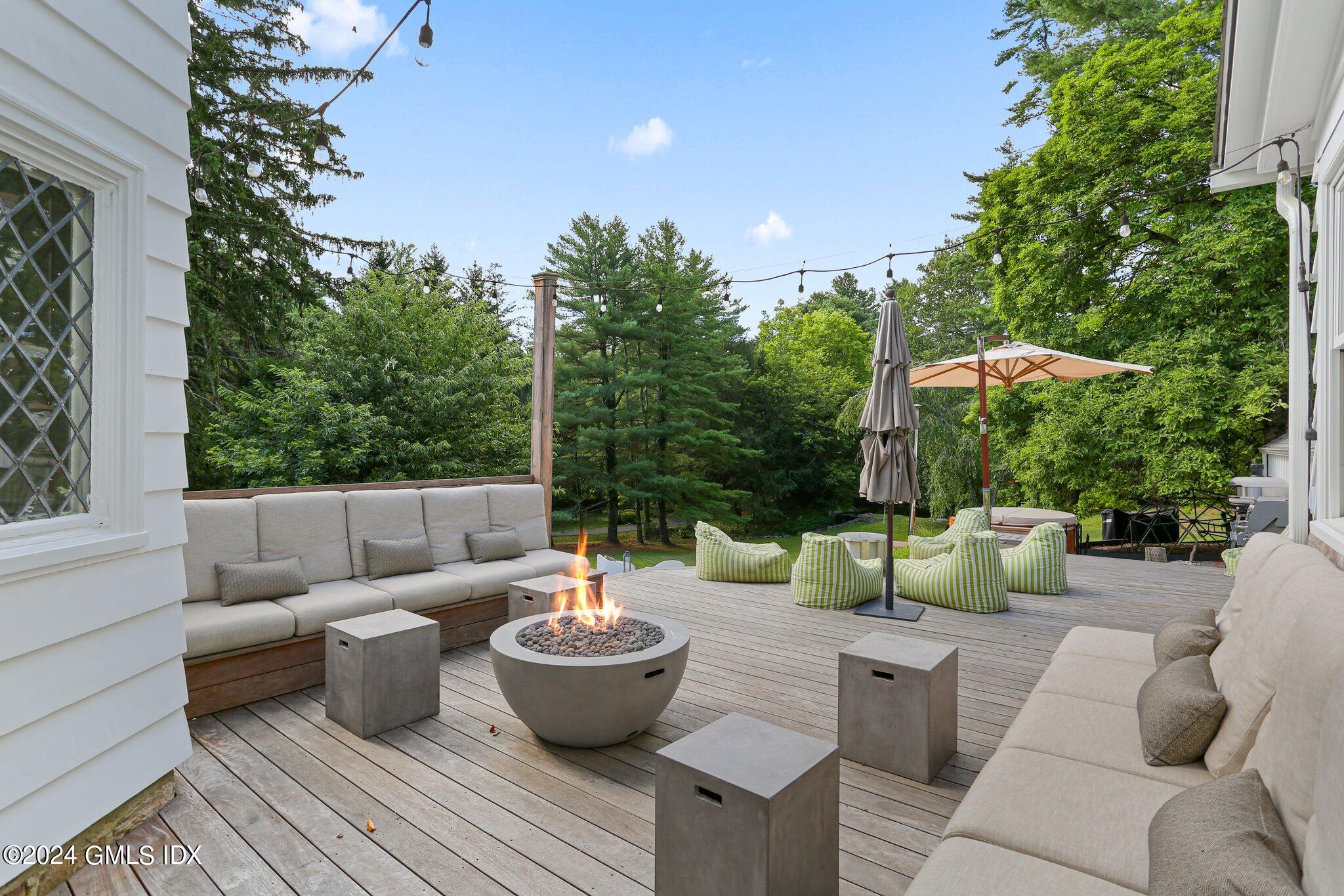 127 Dingletown Road Greenwich, CT 06830 - Photo 40 of 54 a view of a patio with couches chairs and a potted plant