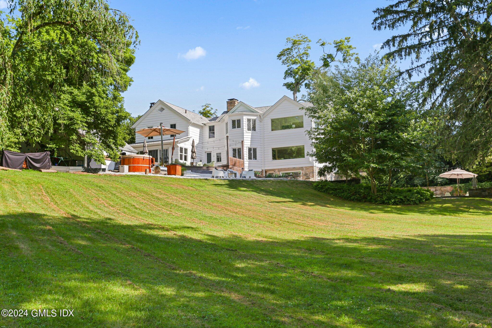 127 Dingletown Road Greenwich, CT 06830 - Photo 45 of 54 a front view of a house with swimming pool having outdoor seating