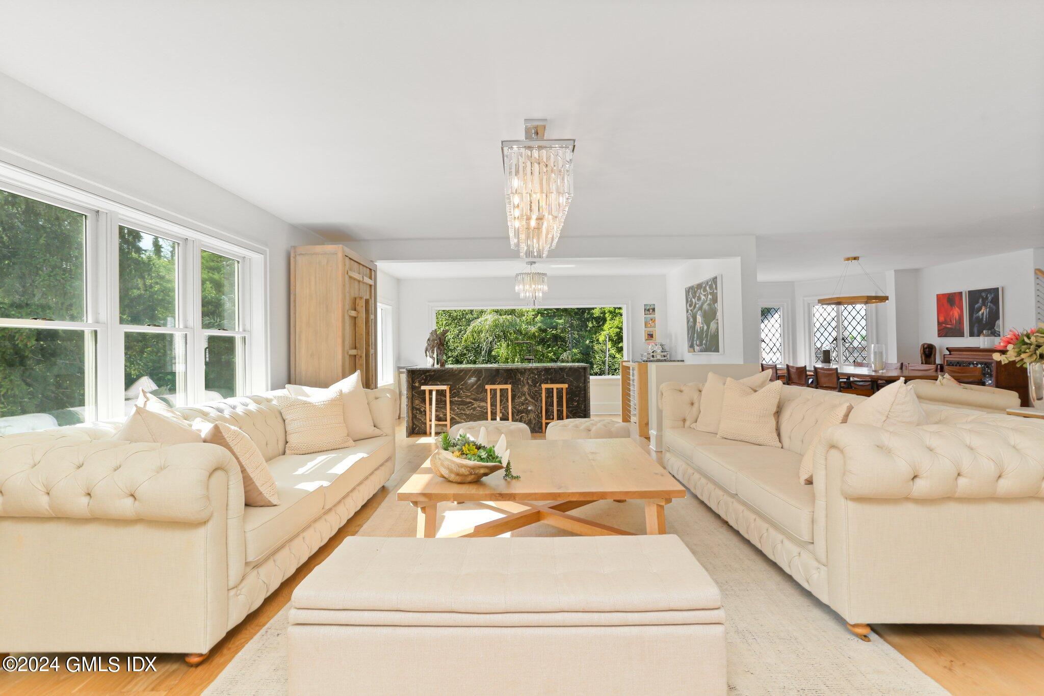 127 Dingletown Road Greenwich, CT 06830 - Photo 9 of 54 a living room with furniture fireplace and large windows