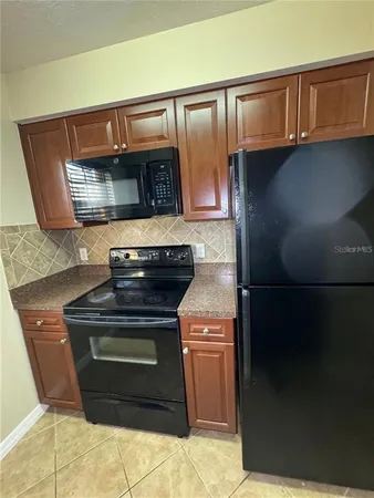 a stove top oven sitting inside of a kitchen