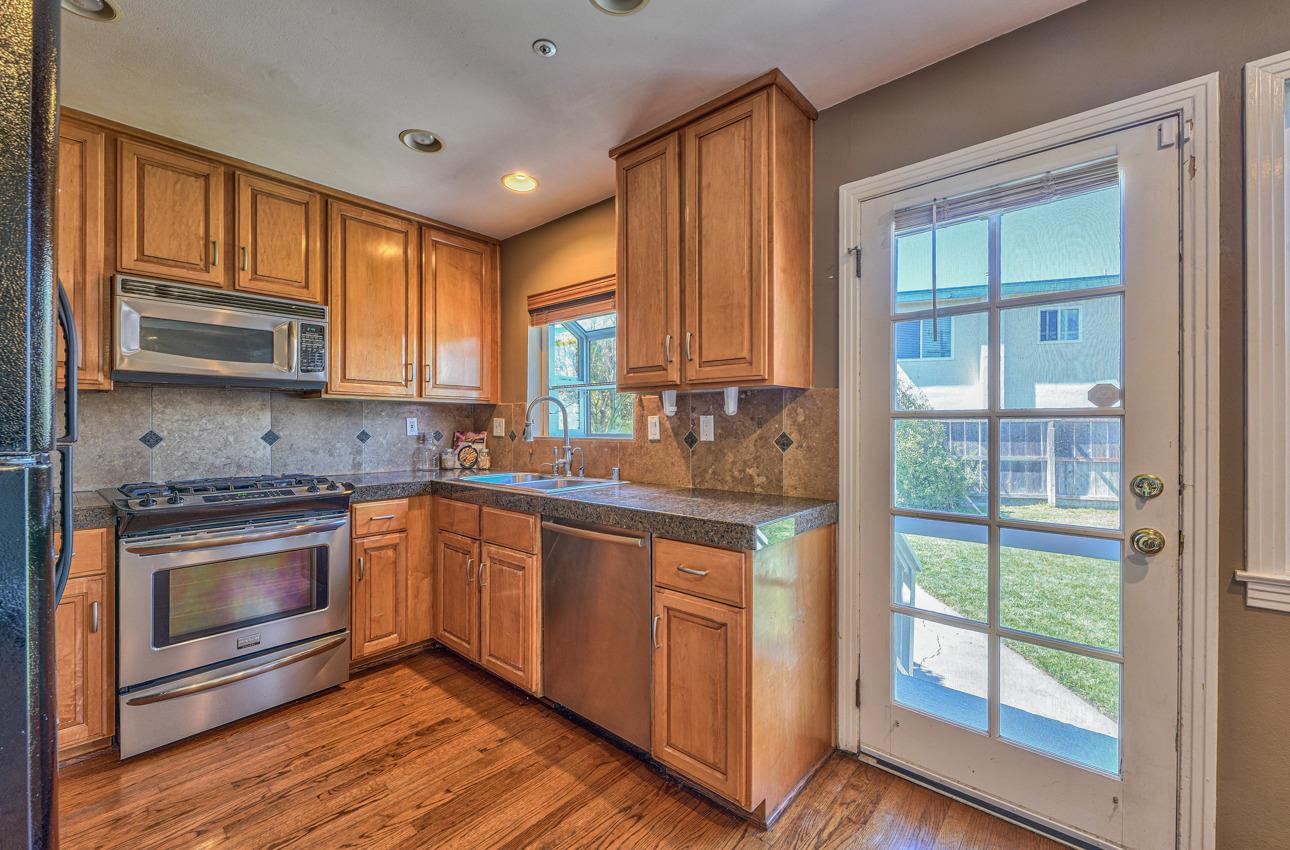 7 Grove Street Salinas, CA 93901 - Photo 11 of 33 a kitchen with stainless steel appliances granite countertop a stove sink and cabinets