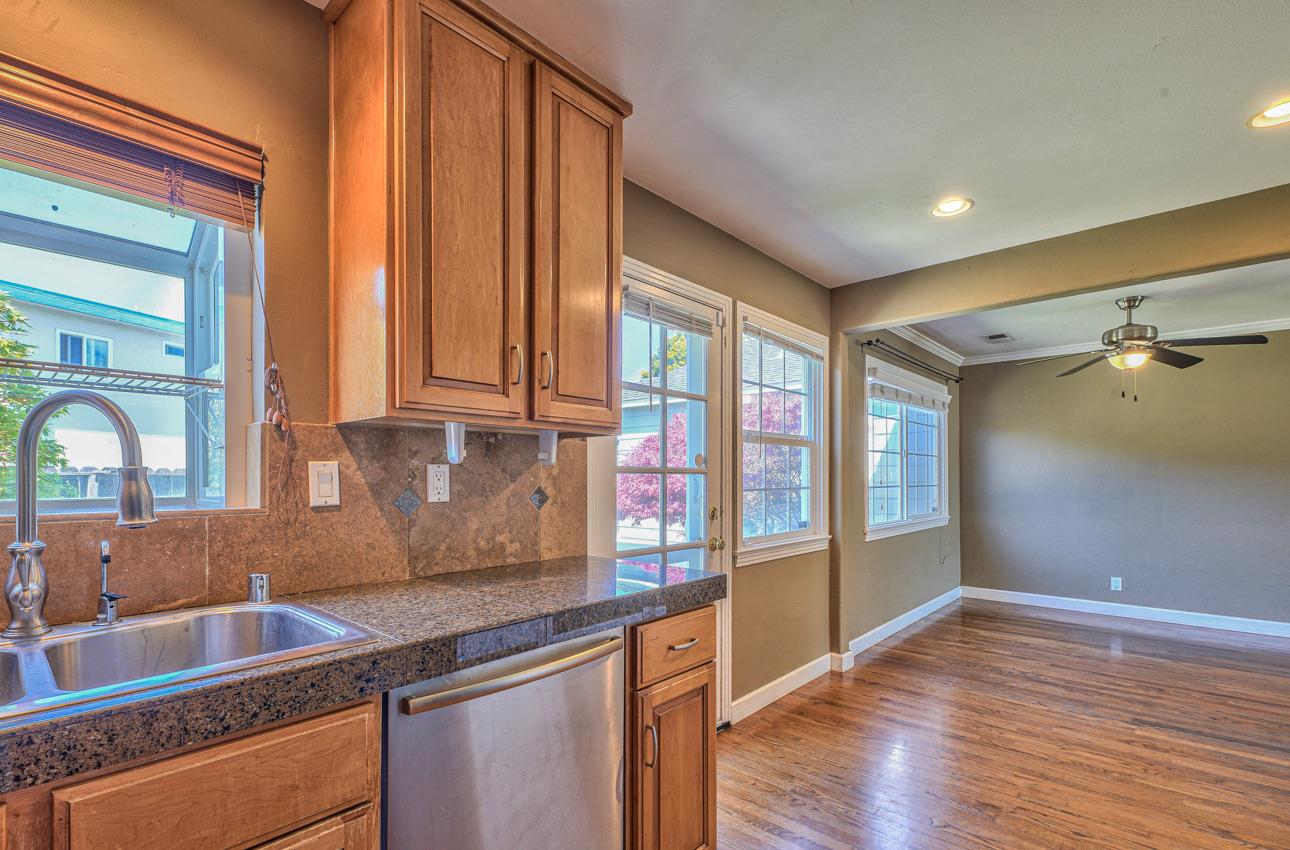 7 Grove Street Salinas, CA 93901 - Photo 13 of 33 a kitchen with granite countertop a sink and a wooden floor