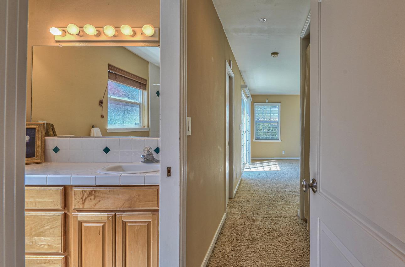 7 Grove Street Salinas, CA 93901 - Photo 15 of 33 a bathroom with a sink a mirror and a vanity