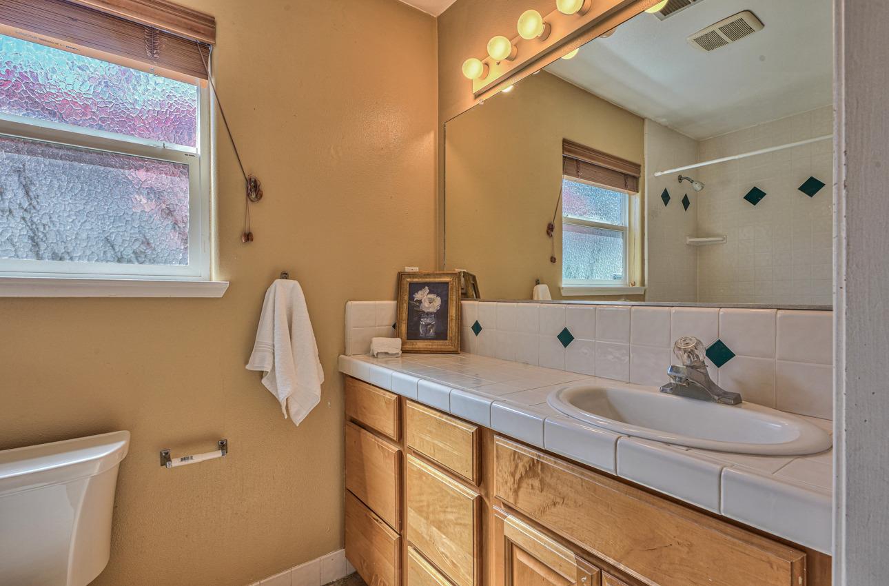 7 Grove Street Salinas, CA 93901 - Photo 19 of 33 a bathroom with a sink and a mirror