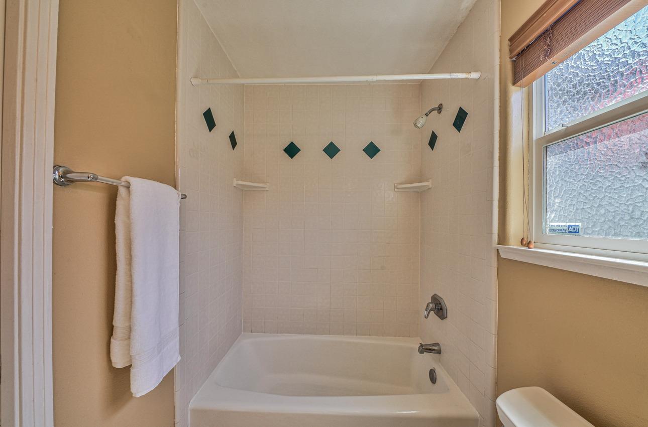 7 Grove Street Salinas, CA 93901 - Photo 20 of 33 a bathroom with a bathtub and a shower