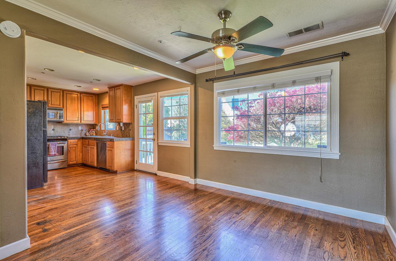 7 Grove Street Salinas, CA 93901 - Photo 8 of 33 a view of an empty room with window wooden floor and a kitchen view