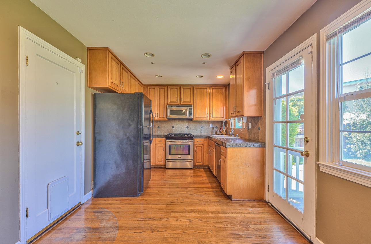 7 Grove Street Salinas, CA 93901 - Photo 10 of 33 a kitchen with stainless steel appliances granite countertop a refrigerator and wooden cabinets