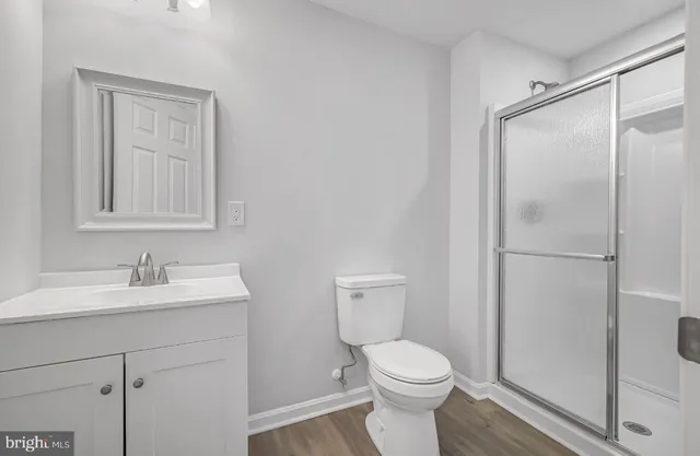 a bathroom with a toilet sink vanity and mirror