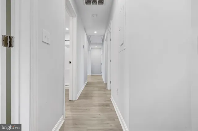 a view of a hallway with wooden floor
